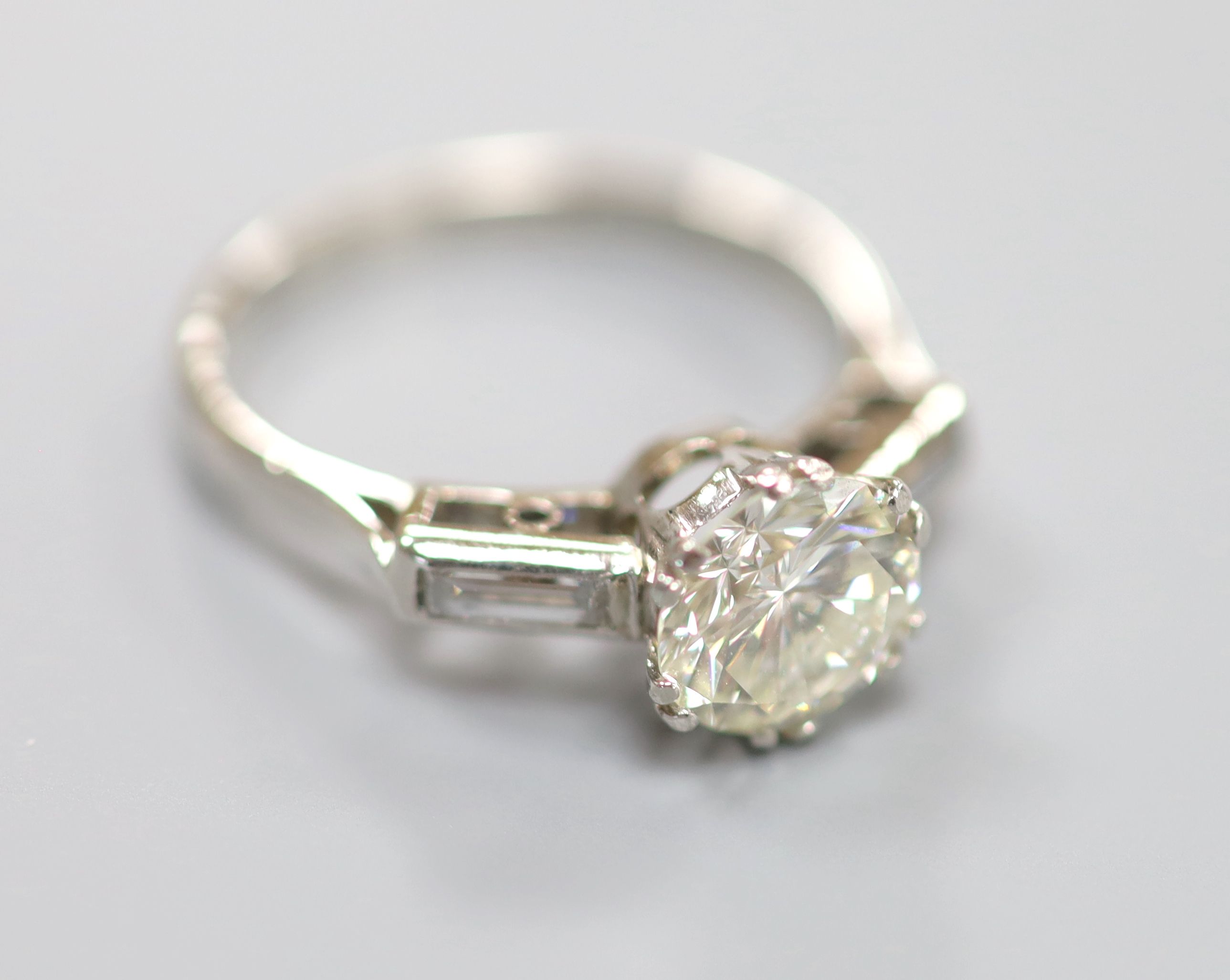 A modern platinum and single stone diamond ring,